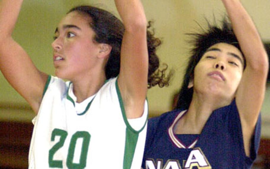 Kubasaki Dragons sophomore Kimi Cece (20) looks to pass the ball as Maki Shinzato (13) of the Naha Bears defends during Friday’s Okinawa-American League girls basketball season opener at Kubasaki High School, Camp Foster, Okinawa. The Bears routed the Dragons 98-60.