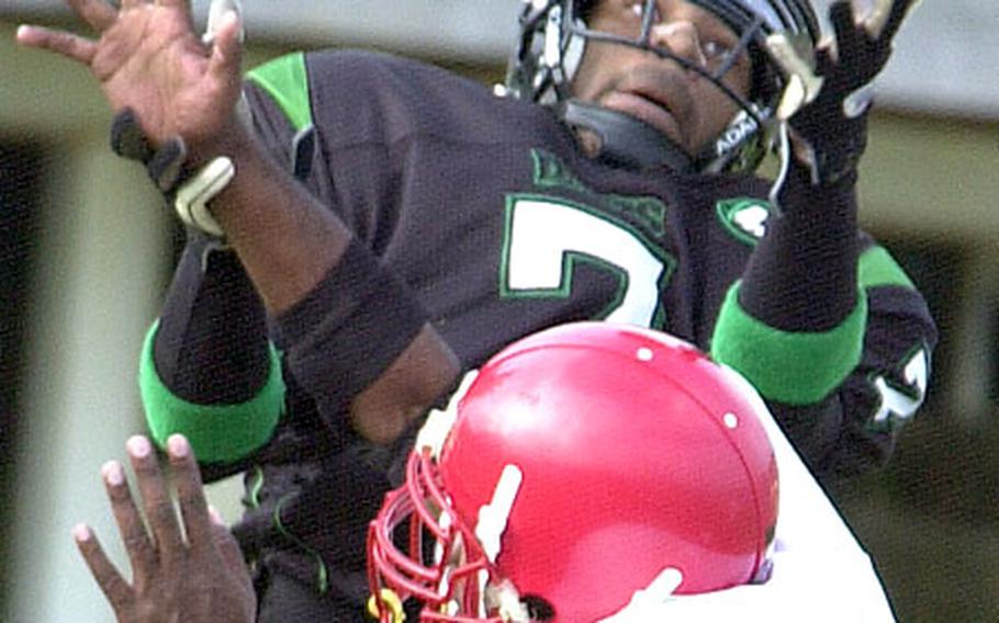 Kadena Dragons wide receiver John Robinson can&#39;t quite get the handle on a pass from quarterback Paul Robinson as Foster-Futenma cornerback Jarvis Vaughn defends during Saturday&#39;s Okinawa Football League game. Kadena rallied past Foster-Futenma 8-3.