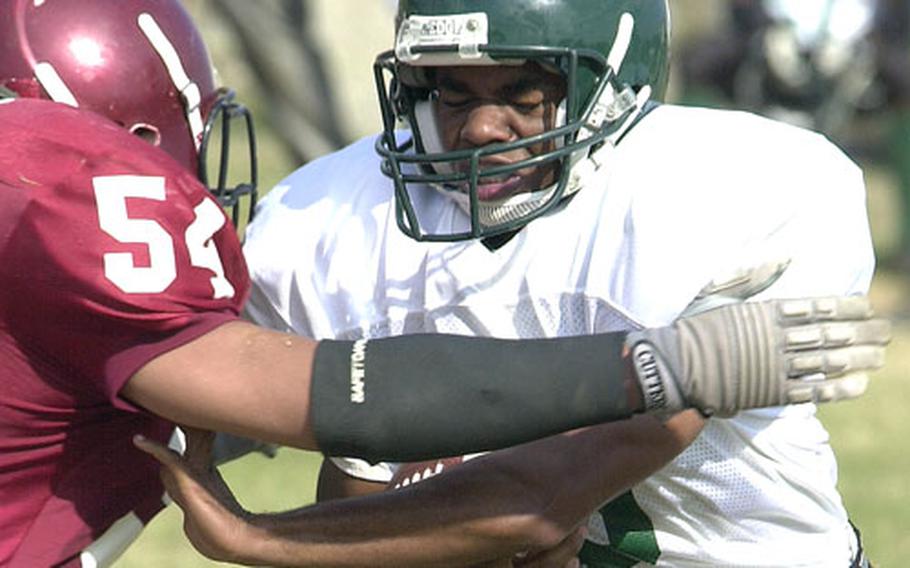 Courtney-Hansen Titans running back Travelle Davis, right, battles with Ryukyu University Stingray defender Ryuzo Sugi during Sunday&#39;s game at Camp Courtney, Okinawa. The Titans beat the Stingray 56-0.