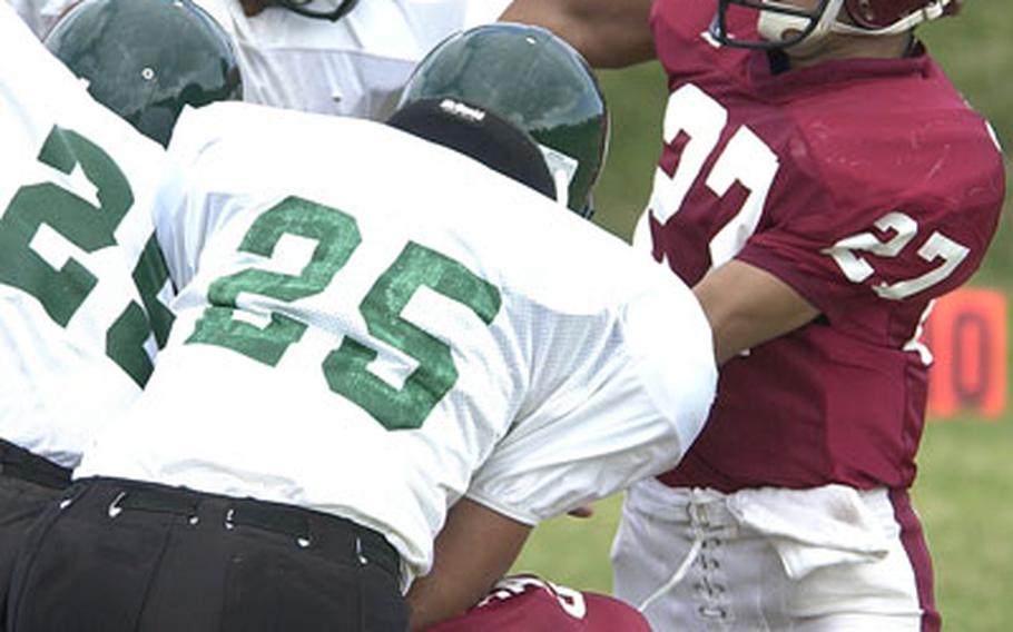Ryukyu quarterback Katsuya Kurihara (27) barely gets a pass away through the rush of a Courtney-Hansen blitz during Sunday&#39;s game.