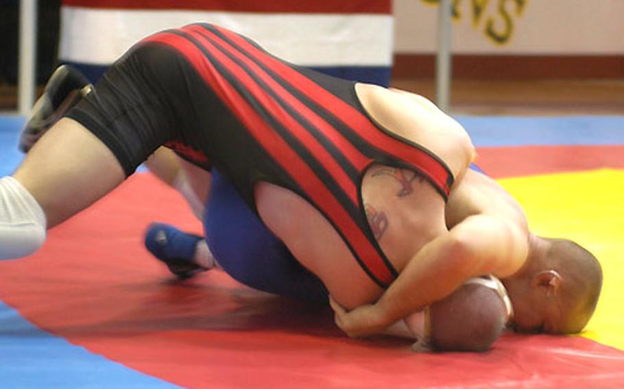 A.J. Werner brings down Bradley Gladbach near the edge of the mat Saturday in the 163-pound championship match in the freestyle portion of the U.S. Forces in Europe wrestling finals in Vicenza, Italy.