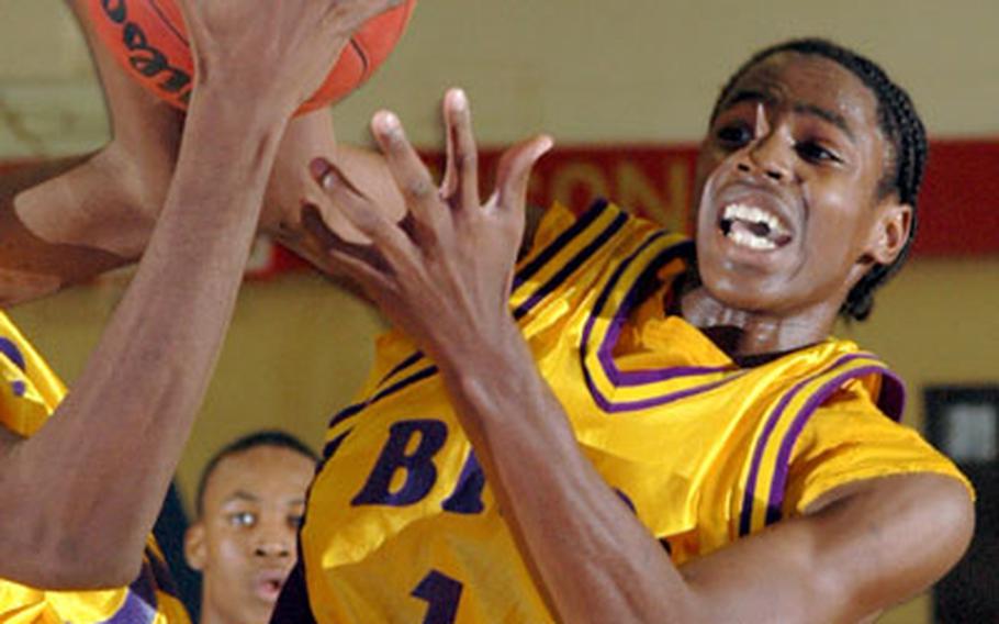 Mannheim&#39;s Edward Williams battles for a loose ball under the basket in opening-day action of the DODDS high school basketball season against Ansbach in Mannheim, Germany, on Friday. Mannheim won, 73-61.