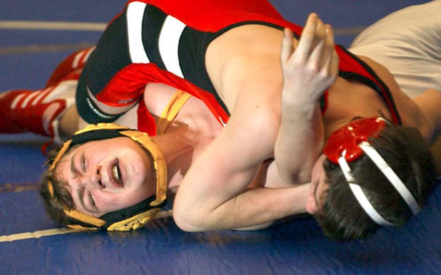 Kaiserslautern&#39;s Bradley George, top, pins Patch&#39;s Kevin Keating to win the 130-pound wrestling match at Ramstein Air Base, Germany, on Saturday.
