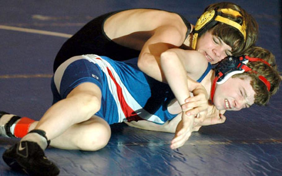 Patch&#39;s Nicholas Rogers, top, tries to flip Ramstein&#39;s Kyle McCrimmon in their 112-pound weight division wrestling match at Ramstein Air Base, Germany, on Saturday. Rogers eventually pinned McCrimmon.