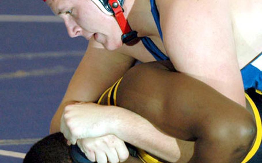 Ramstein&#39;s James Horst, top, gets a tight hold on Heidelberg&#39;s Brandon Simmons during their 275-pound weight division wrestling match at Ramstein Air Base, Germany, on Saturday. Horst pinned Simmons to win the match.