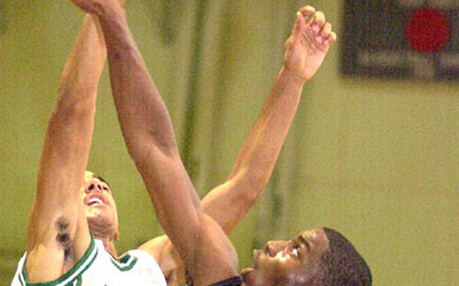 /Stars and Stripes Kadena Panthers’ Z’aire Jackson, blocks a shot by Kubasaki Dragons’ Stephen Thompson (25) on Friday at Camp Foster, Okinawa. Kadena beat Kubasaki 103-93.