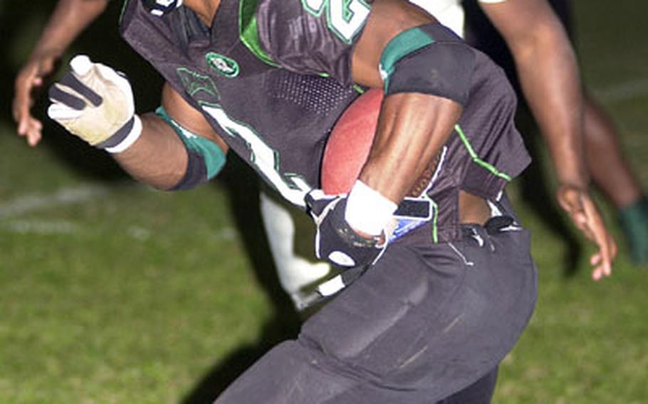 Kadena Dragons running back Trent Beavers (2) looks for running room against the Schwab defense during Saturday&#39;s OFL championship game. Beavers, named the league&#39;s MVP, rushed 24 times for 197 yards and his 30th and 31st touchdowns of the season as the Dragons beat the Panthers 44-14.