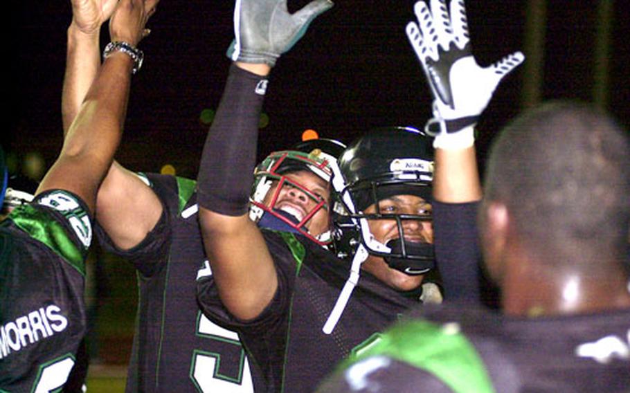 Kadena players celebrate their league title after Saturday&#39;s game.