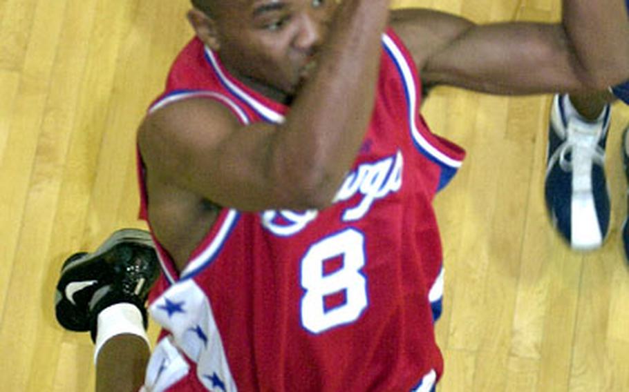 Jacobe George of the Camp Humphreys Bulldogs goes up for a layup against the Osan Defenders. The shot was blocked, but goaltending was called on the play.
