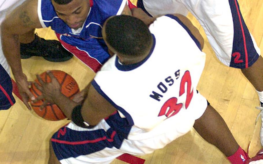 Clifford Claybrooks of Guam&#39;s Andersen Bombers and Ramon Moss (32) of Korea&#39;s Osan Defenders scrap for the ball underneath the basket during Sunday&#39;s game. The Defenders won 79-60.