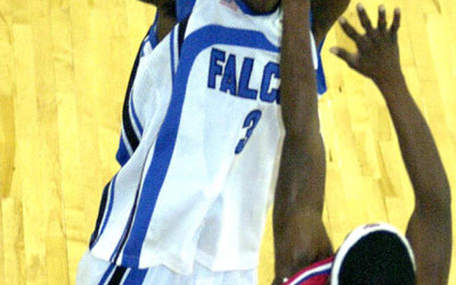 Seoul American junior guard Jamaal Mohn puts up a shot over Bobby Davis of Korea&#39;s Camp Humphreys Bulldogs during Monday&#39;s round-robin play in the 2004 Osan Pacificwide Open Holiday Basketball Tournament. The Bulldogs won 93-83.