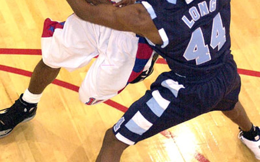 Wallace Ruff, left, of Korea&#39;s Camp Humphreys Bulldogs has the ball slapped out of his hands by Clinton Long of Korea&#39;s Yongsan Runnin&#39; Rebels during Tuesday&#39;s game, which the Bulldogs won 91-77.