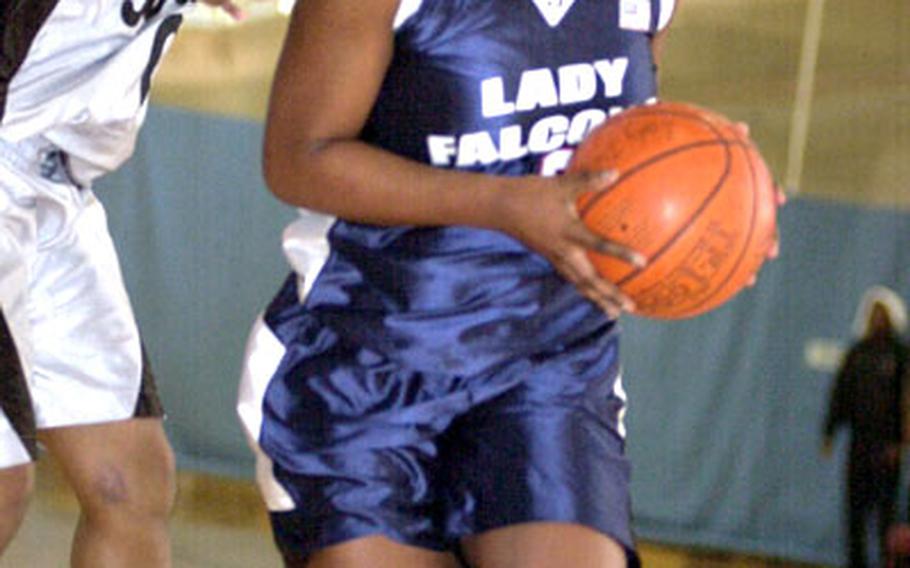 Senior Janel Daniels of the Seoul American High School Falcons drives to the basket during Tuesday&#39;s round-robin play. The Falcons upset the Cobras, 55-41, the first victory by a girls high school team since the Osan tournament&#39;s inception in 1987.