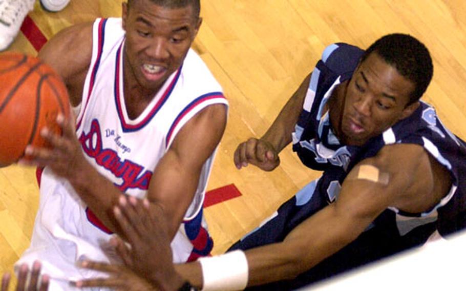 Jacobe George, left, of Korea&#39;s Camp Humphreys Bulldogs drives for a shot as Kendall Jackson of Korea&#39;s Yongsan Runnin&#39; Rebels defends during Tuesday&#39;s first-round playoff game. The Bulldogs won 91-77.