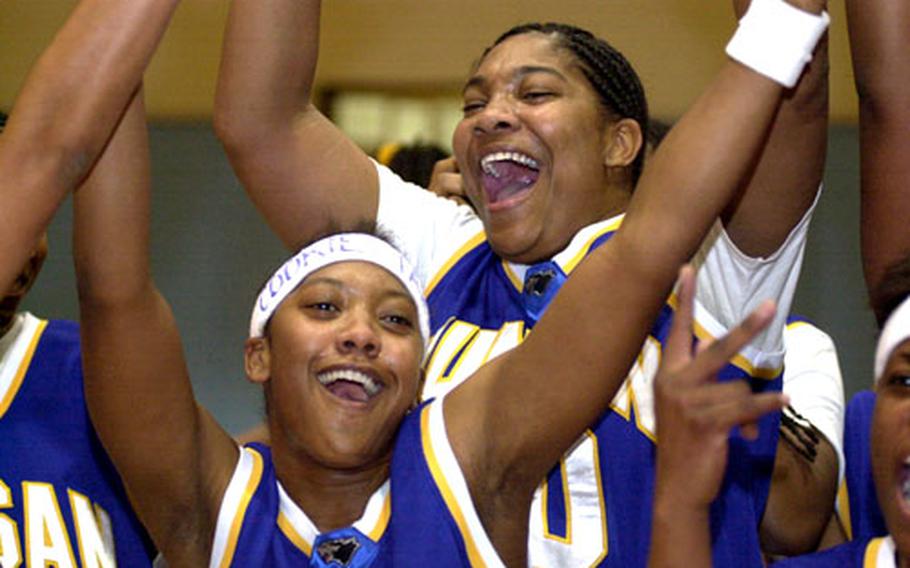 Members of Korea&#39;s Kunsan Wolf Pack celebrate their women&#39;s championship in the 2004 Osan Pacificwide Open Holiday Basketball Tournament.