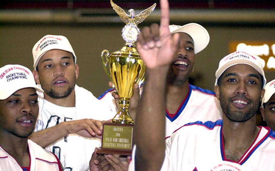 Andersen Bombers players display the championship trophy from the 2004 Osan Pacificwide Open Holiday Basketball Tournament.
