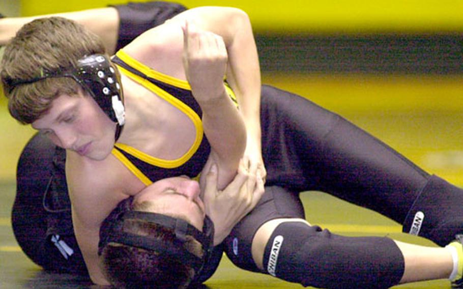Chris Hoshaw of the Kadena Panthers locks Jack Abate of the Kubasaki Dragons in a cradle during the 101-pound bout in Friday&#39;s wrestling meet at Kadena. Hoshaw won by pin in 48 seconds, and the Panthers beat the Dragons 34-20.