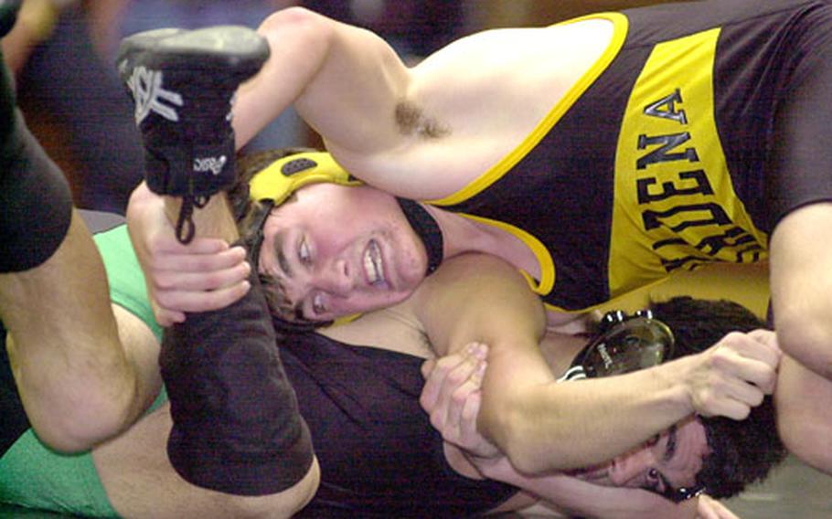 Kadena&#39;s Ian Copeland grabs the ankle of Kubasaki&#39;s Jason Paul during Friday&#39;s 158-pound bout. Copeland eked out a 5-4 decision.