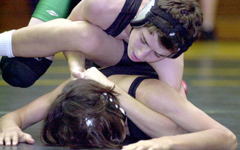 Cameron Daugherty of Kubasaki gets the upper hand on Zack Rinehart of Kadena during Friday&#39;s 108-pound bout. Daugherty pinned Rinehart in 1 minute, 47 seconds.
