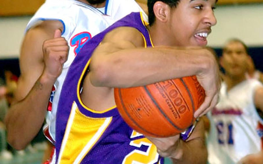 Würzburg&#39;s Anthony Womack steps in front of Ramstein&#39;s Marquiston Showers to grab a rebound during a DODDS high school basketball matchup Friday night in Ramstein, Germany. Ramstein breezed past Würzburg 63-44, to avenge an earlier 32-31 defeat and hand Würzburg its first loss of the year.