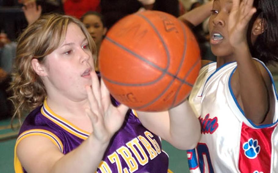 Würzburg&#39;s Jennifer Snyder, left, and Ramstein&#39;s Kendra Lenoir battle for a loose ball during a DODDS high school basketball game Friday night in Ramstein, Germany. Ramstein won, 38-11.