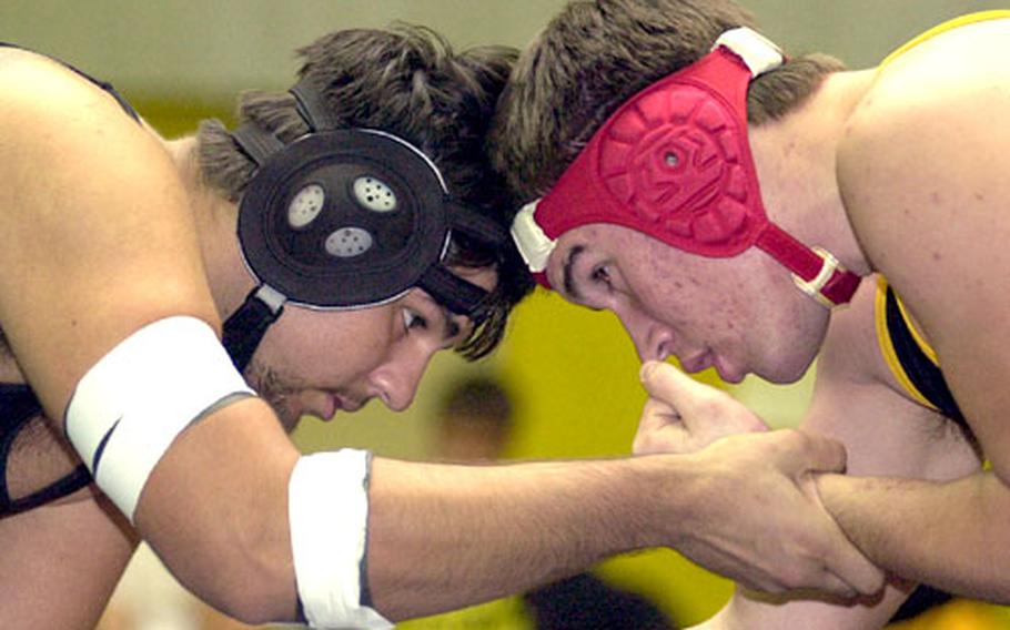 Kubasaki Dragons junior heavyweight Paul Haecherl, left, battles for control against Grady Pennell of the Kadena Panthers during a dual meet on Jan. 7, 2004 at Kadena Air Base, Okinawa. Haecherl spent the fall playing left tackle for the Puyallup High School Vikings in Washington state, and has his sights set on playing Division I college football.