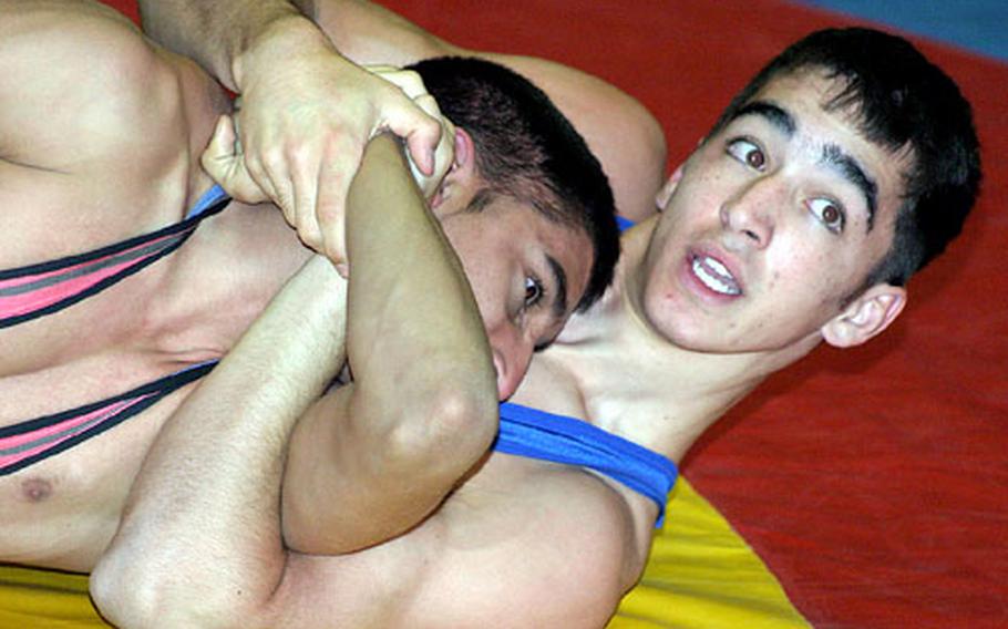 Menwith Hill senior Cole McClain, right, controls British champion Gurdet Badesha during his 7-4 victory over Badesha at the Aspull International tournament in Wigan, England, last November. McClain has been training with the British National Freestyle team.