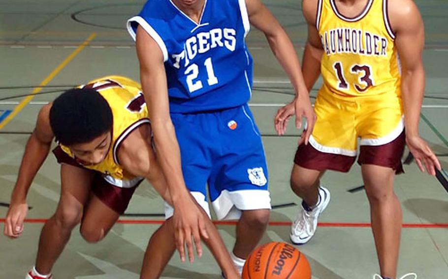 Baumholder&#39;s Tyrick Bayne, left, reaches in to swipe the ball away from Hohenfels&#39; Jason Parks as Antonio Mouzon, 13, defends at right during Friday&#39;s game at Baumholder, Germany. Hohenfels beat Baumholder 61-52.