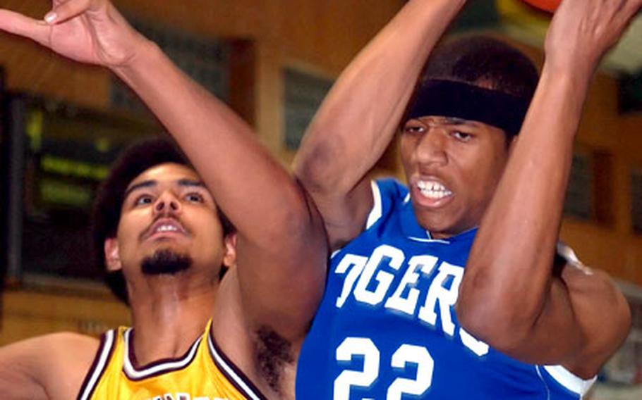 Hohenfels&#39; B.J. Denson, right, grabs a rebound over Baumholder&#39;s Alex Eng during Friday&#39;s game.