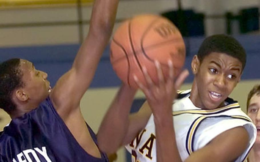 Hanau&#39;s Xavier James, right, is stopped in the paint by Bitburg&#39;s Perry Hardy during a DODDS high school basketball matchup in Hanau, Germany, Friday night. Bitburg defeated Hanau 41-35.