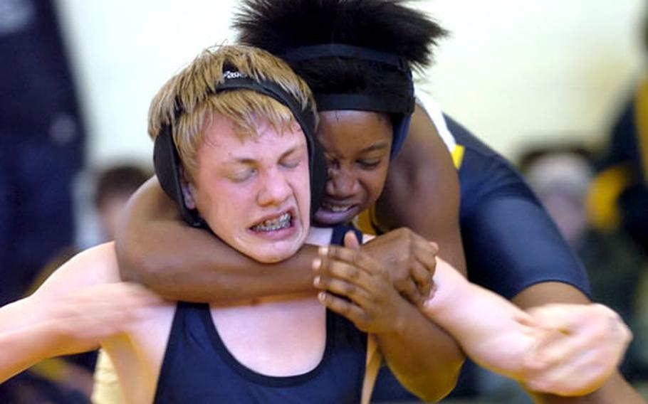 Ansbach&#39;s Jasmine Thompson, right, tightens the grip on a headlock on Lakenheath&#39;s Lance Beissner during a 130-pound high school wrestling match in Wiesbaden, Germany, on Saturday. Beissner mon the match on points, 12-9.
