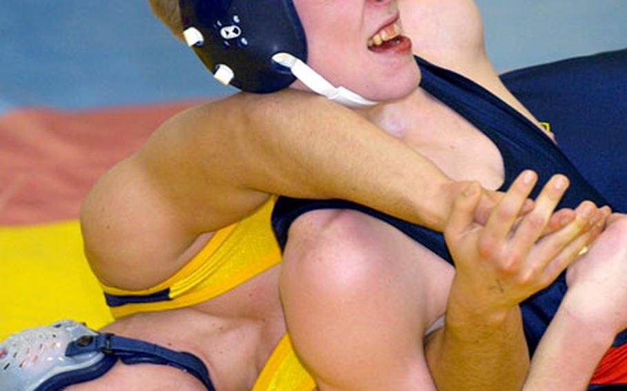 Lakenheath&#39;s Craig Campbell, top, and Heidelberg&#39;s Adam Johnson battle for position during the first-place match in the 130-pound division at Wiesbaden, Germany, on Saturday. Johnson won the match on points 10-8.