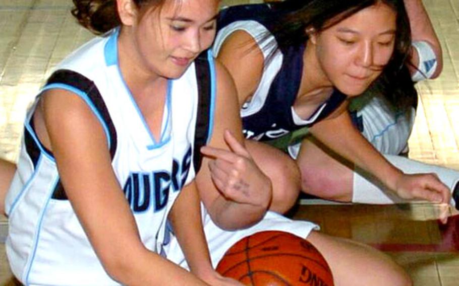 Mina Davis, left, battles for possession during a game against International Christian-Seoul.