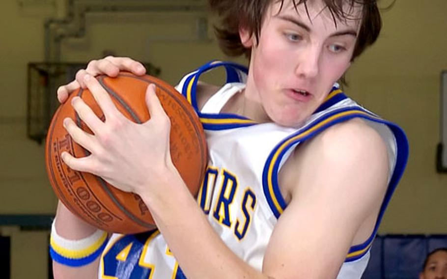 Wiesbaden&#39;s Thomas Lawler snatches a rebound during a Friday night&#39;s game against SHAPE in Wiesbaden, Germany.