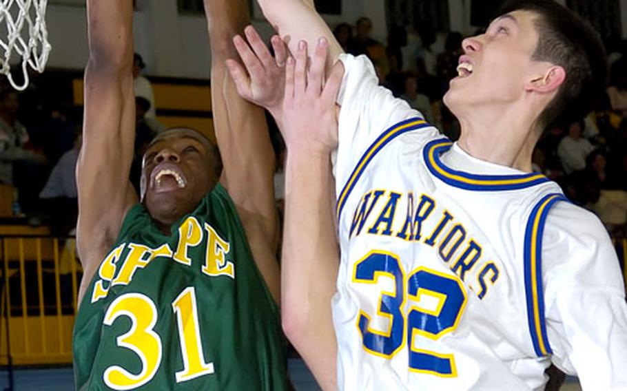 SHAPE&#39;s V.J. Fowler, left, blocks the shot of Wiesbaden&#39;s Chris Dyer. Fowler scored 34 points and blocked several shots.