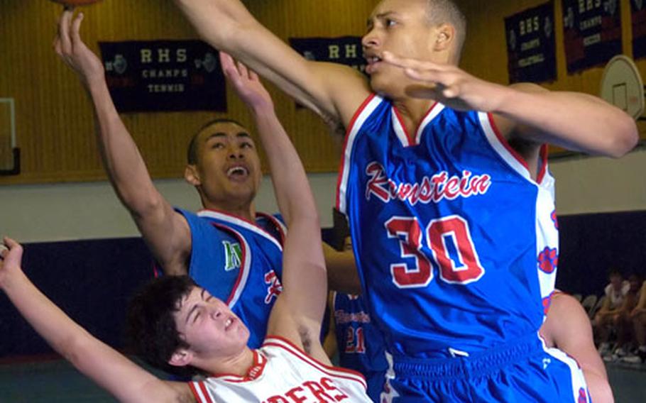 International School of Brussels&#39; Guy Gershon loses a battle for the ball with Ramstein&#39;s Daniel Dixon and Alex Tremble, right, during Ramstein&#39;s 55-33 victory on Saturday.