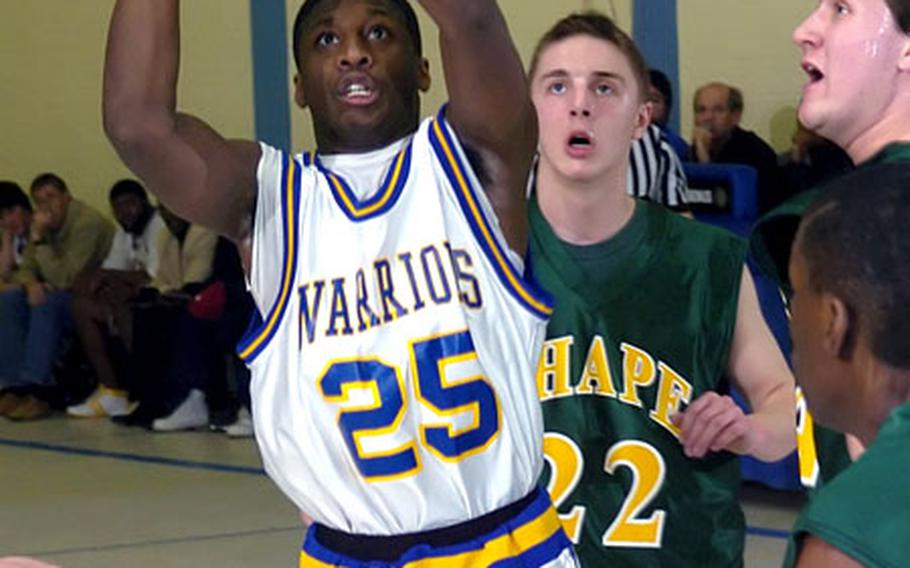 Wiesbaden&#39;s Robert Edwards sinks a jumper between a trio of SHAPE defenders.