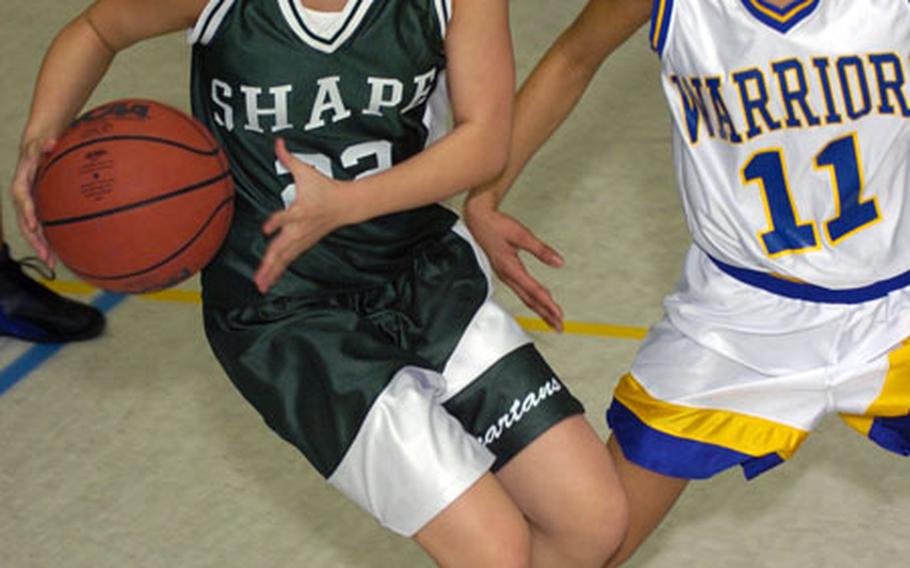SHAPE&#39;s Ashley McGee, left, pulls up for a shot against Wiesbaden&#39;s Brittany Harris Friday night in Wiesbaden, Germany.