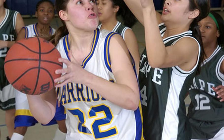 Wiesbaden&#39;s Nancy Jensen, left, drives to the hoop as SHAPE&#39;s Justine Shelton defends during Wiesbaden&#39;s 52-27 victory on Friday.