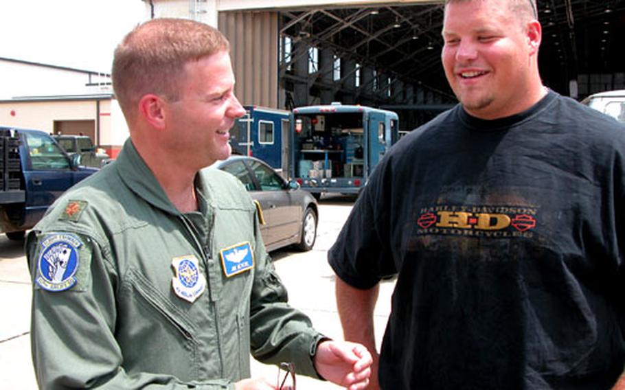 Maj. James Devere of the Air Force Reserve&#39;s 913th Airlift Wing speaks with Hank Fraley, Philadelphia Eagles center, during last summer&#39;s unveiling of new Eagles logos on the wing&#39;s C-130E tails. Devere is a season ticket holder for the Eagles.
