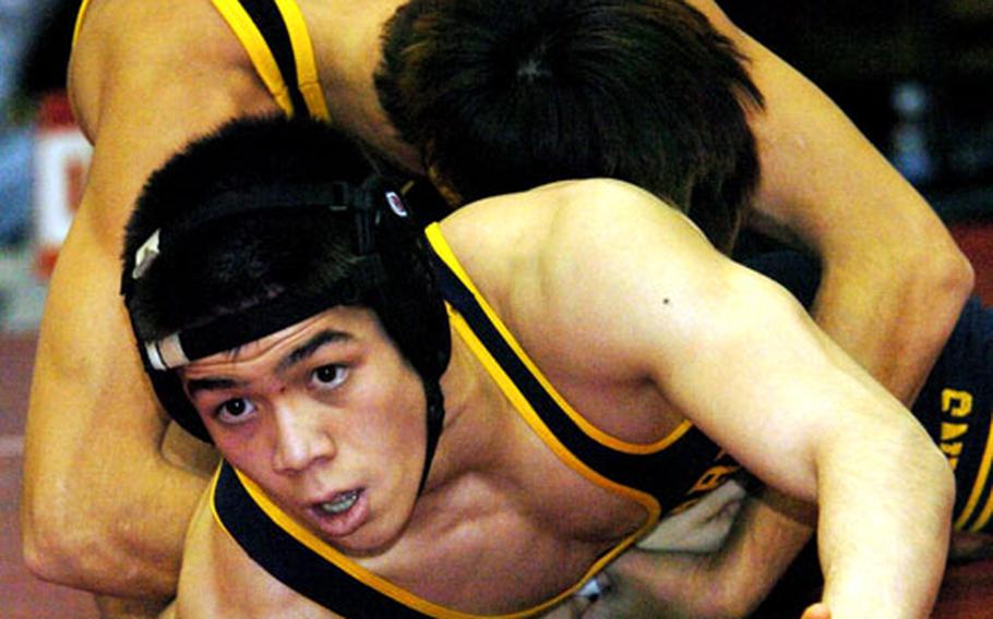 Two-time Far East champion Mark Striegl of St. Mary&#39;s International finds himself in the grip of Kadena&#39;s Brenden Stanford during the 135-pound championship bout of Saturday&#39;s Nile C. Kinnick Invitational Wrestling Tournament at Yokosuka Naval Base, Japan. Striegl rallied for a 6-4 decision over Stanford.