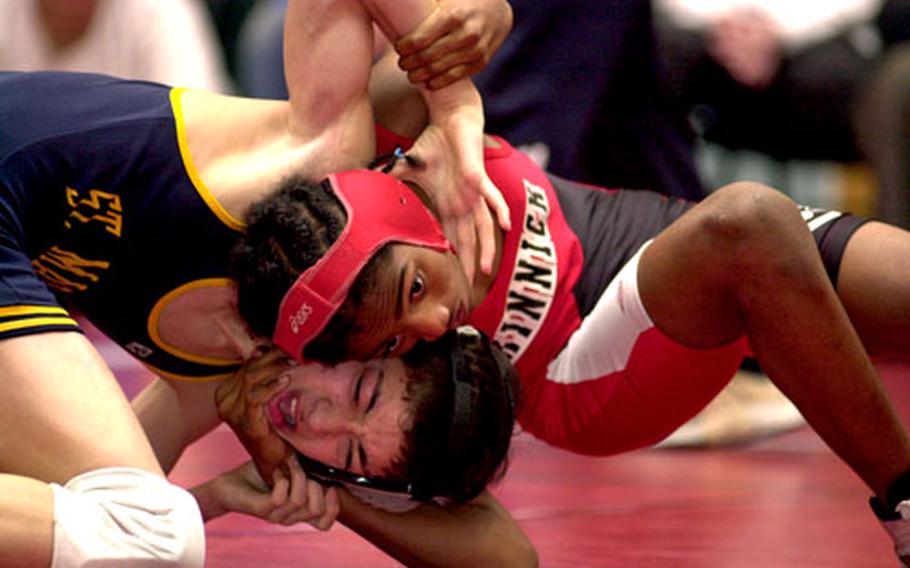 Mikey Guilfoile, left, of St. Mary&#39;s International grimaces as he tangles with Reggie Barton of Nile C. Kinnick during the 101-pound championship bout. Guilfoile won an 8-5 decision.