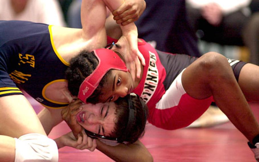 Mikey Guilfoile, left, of St. Mary&#39;s International grimaces as he tangles with Reggie Barton of Nile C. Kinnick during the 101-pound championship bout of Saturday&#39;s Nile C. Kinnick Invitational "Beast of the Far East" Wrestling Tournament at Yokosuka Middle School Gym, Yokosuka Naval Base, Japan.