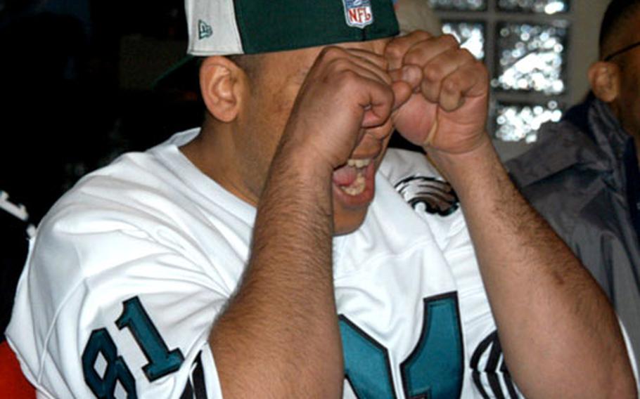 Pfc. Onaje Taylor covers his eyes during the final seconds of the Eagles’ loss on Sunday. Taylor, 26, of Atlanta, watched the Super Bowl at the Main Post Club on Yongsan Garrison in Seoul.
