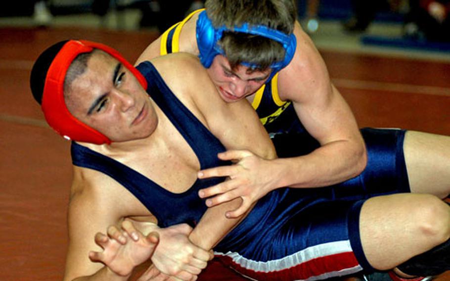 Aviano&#39;s Pablo Martinez tries to escape from Ansbach&#39;s John Swanson during their 125-pound match Saturday at the regional qualifying tournament at Aviano. Swanson held on for a 5-0 win and a berth at the European championships.