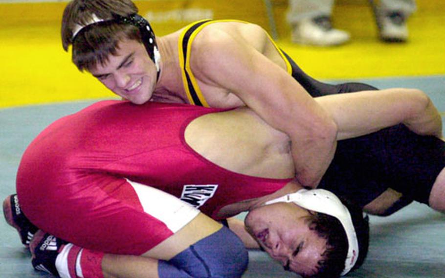 Joey Wood, bottom, of Nile C. Kinnick grimaces during his 168-pound championship match with Devon Copeland of Kadena. Copeland decisioned Wood 5-4 in overtime.