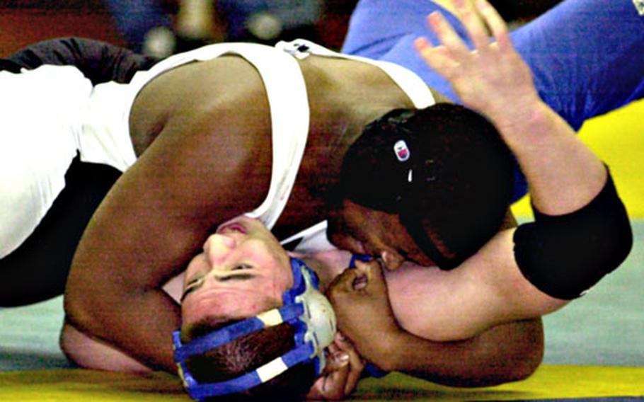 David Burnett, top, of Zama American tries to pin Seoul American&#39;s Scott Tunis during Friday&#39;s 215-pound championship bout. Burnett pinned Tunis in 4 minutes, 36 seconds.