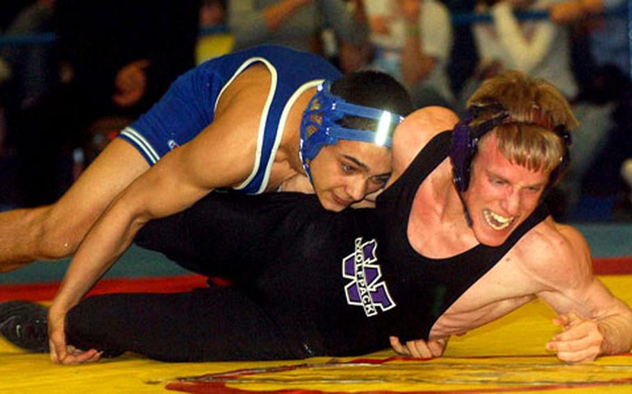 Würzburg&#39;s Jonathan Painter, right, tries to get out of the grasp of London Central&#39;s Jonathan Scott in the 130-pound final. Scott won the match to capture the 2005 DODDS wrestling crown.