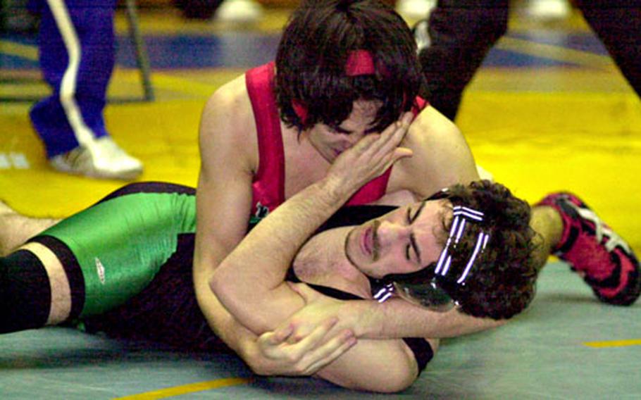 Kenji Doughty, top, of Japan's Nile C. Kinnick Red Devils locks up Willie Stroud of Okinawa's Kubasaki Dragons with a head-and-arm hold during Saturday's championship of the dual-meet portion of the 2005 Far East High School Wrestling Tournament at Yokota High School, Yokota Air Base, Japan. Doughty pinned Stroud in 3:40, but Kubasaki prevailed over Kinnick in the dual meet 26-26 on pinfall criteria.