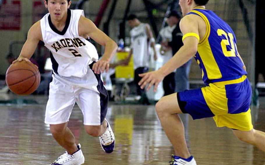 Kadena guard Anthony Soroka drives on Yokota defender Shaun Novak during their Far East Boys Class AA tournament game on Camp Foster on Monday. Strong Kadena rebounding and Yokota turnovers helped give Kadena a 51-40 victory. (spt# 43p cs)